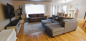 Living room, smart TV, trunk holds throw blankets.