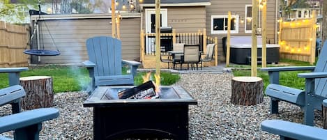 Backyard fire pit space. Privacy fence on all sides. 6 person hot tub