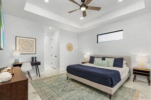 King-size bed and designated workspace in the master bedroom.