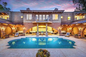 View upon arrival entering from the carport through giant French doors opening to the massive courtyard with the perfectly private walk-in Roman pool, snooker lounge and plenty of outdoor seating