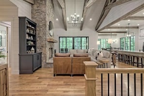 Open living space on the main floor that includes sliding doors leading to grill