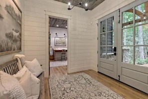Open & airy, featuring ship lap walls and pine ceilings throughout.