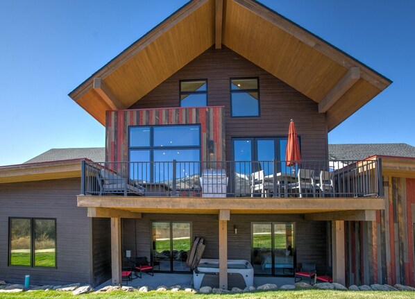 Back of Home with 2 Patios, Grill, & Ground Level Hot Tub
