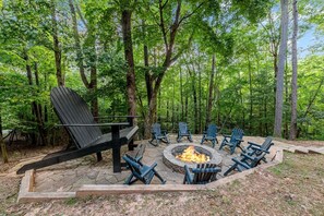 Rear view of the patio w/ firepit Giant Adirondack Chair from the rear cabin