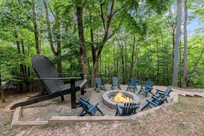 Rear view of the patio w/ firepit Giant Adirondack Chair from the rear cabin