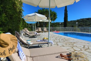 Sunbathing by the pool in comfortable sunloungers