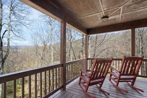 Main Floor Deck with Rocking Chairs and Seasonal View