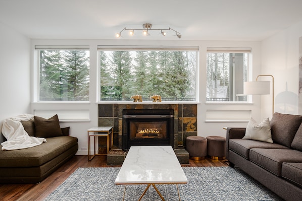 Living Room - Centered by a cozy fireplace with an abundance of natural light
