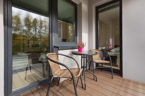 A private balcony with a small table and chairs, ideal for enjoying the view and fresh air.
