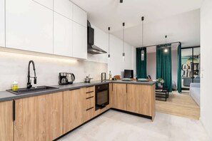 A functional and spacious kitchen with wooden cabinetry, white accents, and high-quality appliances.
