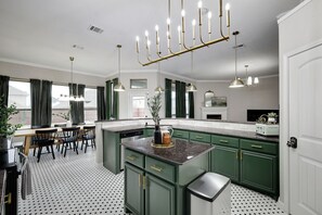 This impressive kitchen is fully equipped for all your cooking needs, including ample counter space, a kitchen island, and a breakfast bar!