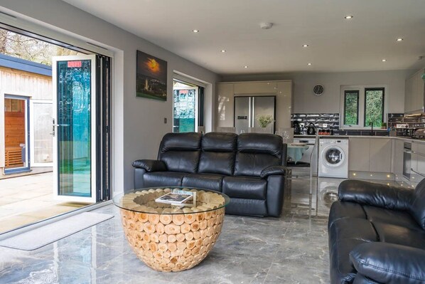 Open space kitchen living dining room with two bi-folding doors to the terrace.