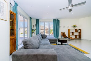 Spacious living room with wall mounted flat screen TV