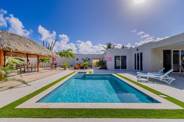 Luxury pool area of the apartment in Noord, Aruba - Lush and refreshing environment - Cozy beach chairs available - Beautifully sunbathed space makes the soul peaceful  - Experience the comfort at the best