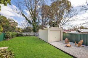  The pet-friendly stay includes a grassy, fully enclosed backyard for relaxing and entertaining, as well as a fire pit to keep you warm in the evening. 
