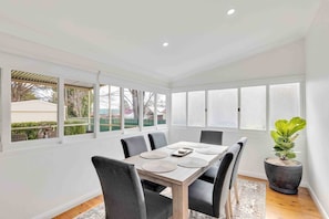 The light-filled dining area offers a generous six-seater table to enjoy meals together.