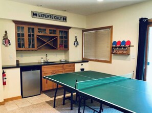 Downstairs • Game Room • 65" Roku TV • Hulu Live TV • Large DVD Selection • Ping Pong Table • Knock Hockey • Wet Bar