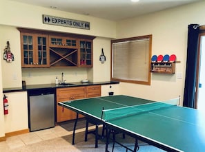 Downstairs • Game Room • 65" Roku TV • Hulu Live TV • Large DVD Selection • Ping Pong Table • Knock Hockey • Wet Bar