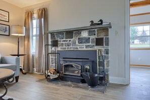 A wood burning fireplace is located in the living room for cozy nights