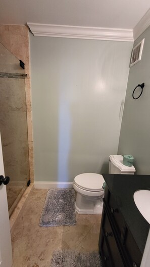 Shared bath in the hallway with a walk-in shower