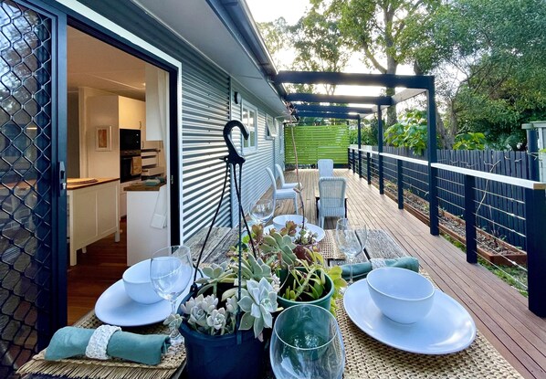 Enjoy eating at the tree stump table on the back deck under the banana fronds. 