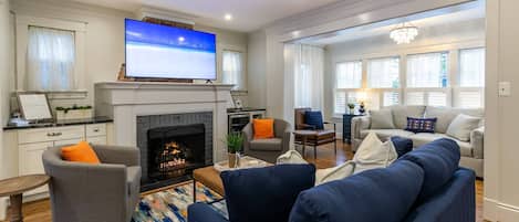 The spacious family room has a flatscreen TV, remote-powered gas fireplace, and beverage fridge.