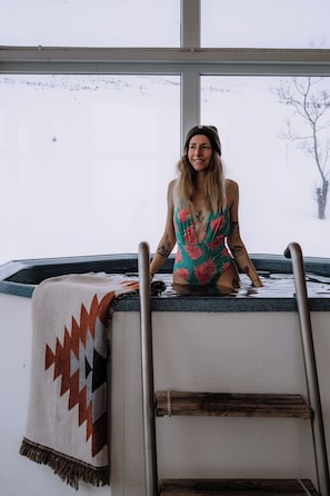 Geothermal hot tub in the glass salon