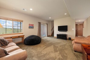 Lower level living area with smart tv, Wii  and an oversized bean bag