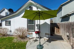 back patio, grill and fenced in yard for privacy