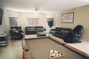 Living room includes pool table and massage chair 