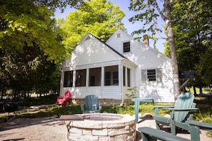 Charming updated historic cottage with stunning lake views from the back patio and fire pit area.