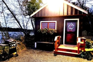 Deck with bench seat onto patio with deck box for storage & lake access.