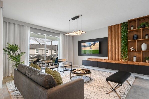 Modern living room with natural light, sleek décor, and stylish indoor greenery.
