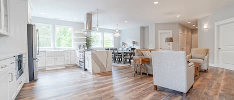 Open concept kitchen, dining area, and fire side lounge.