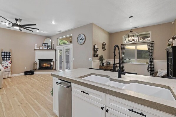 Living room has a cozy fire log fireplace and a French door leads to the patio.