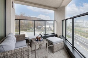 A spacious balcony overlooking the area, furnished with comfortable outdoor seating.