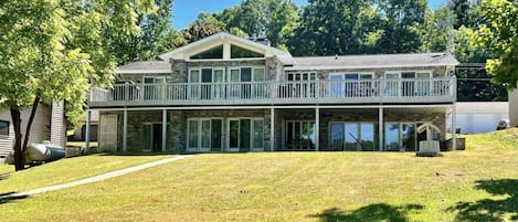 Back of the house with gently sloping lawn to water.  Amazing outdoor space!