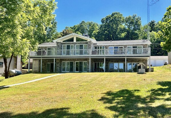 Back of the house with gently sloping lawn to water.  Amazing outdoor space!