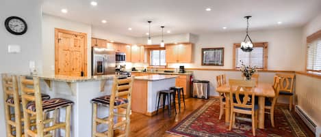 Kitchen and Dining Area - Spacious, fully-equipped kitchen, breakfast bar area, and dining room.