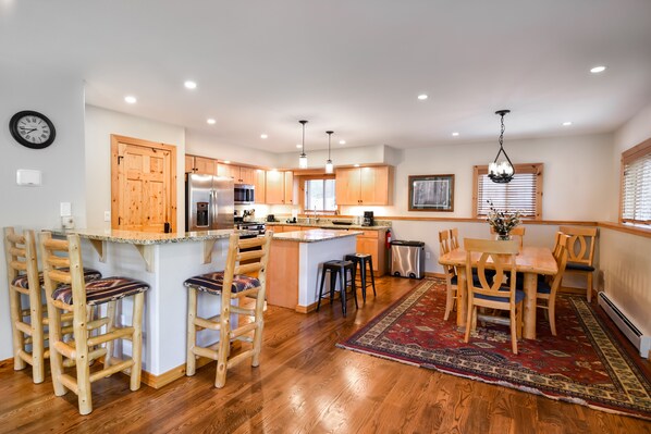 Kitchen and Dining Area - Spacious, fully-equipped kitchen, breakfast bar area, and dining room.