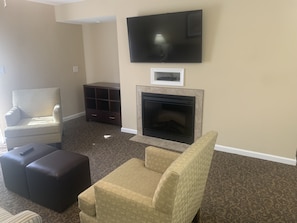 Your living room has a pull-out couch, TV, electric fireplace & plenty of seats
