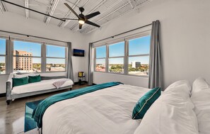 You'll feel on top of the world in this 5th floor corner unit in the Behrens loft building in downtown Waco. This unique bedroom is outfitted with a king and twin memory foam mattresses.