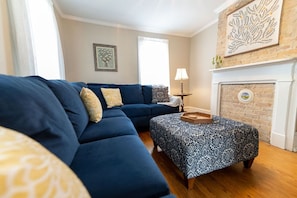 One of two living spaces, this room provides a large sectional and smart TV.