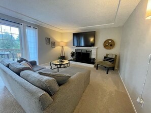 Upstairs living room with 70" smart TV and sound bar