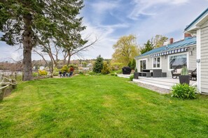 Back deck with a BBQ grill and sitting area w/awning