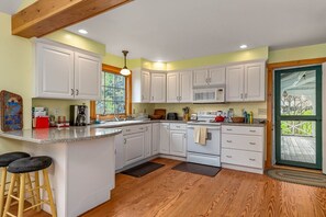 Kitchen area door to outside washer and dryer and half bath