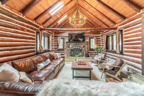 Orinal 1930s log cabin completely updated with massive leather L-shaped couch