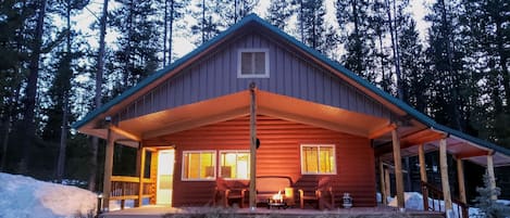 The Bonanza Cabin - behold the enchanting view from the front of the cabin as the day gently transitions to night, creating a serene and captivating ambiance.