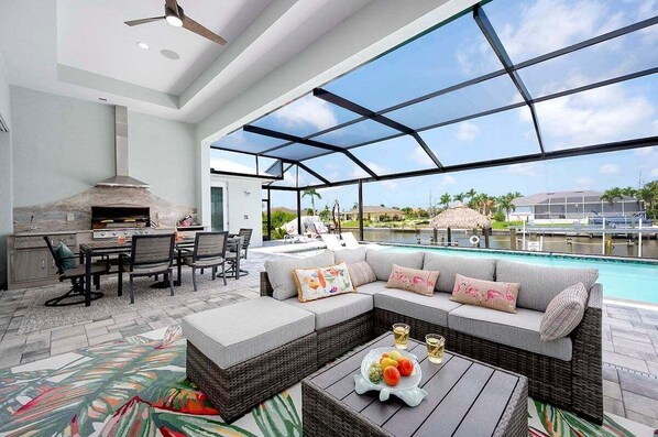 Covered Lanai Lounge Area with TV, Outdoor Kitchen and Al Fresco Dining