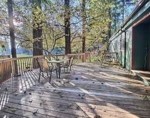Expansive outdoor deck. Propane BBQ. Seating/table and golf course view.